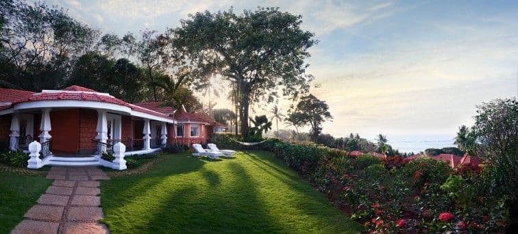 Luxury hotel with trees, grass and sunset view near beach