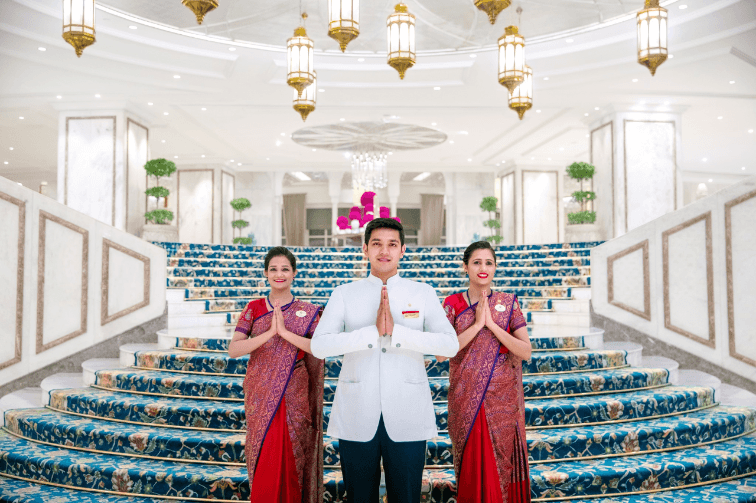 Hospitality associate greeting guests with a warm and courteous smile