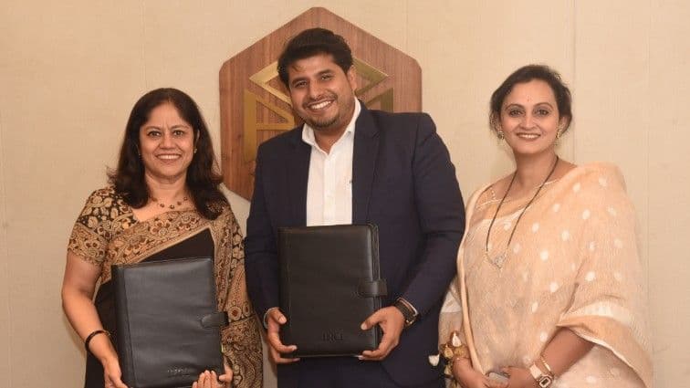 Three professionals holding document folders after a business agreement signing.